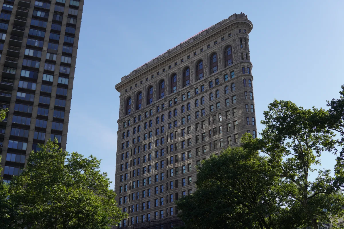 The Flatiron Building beneath a clear blue sky