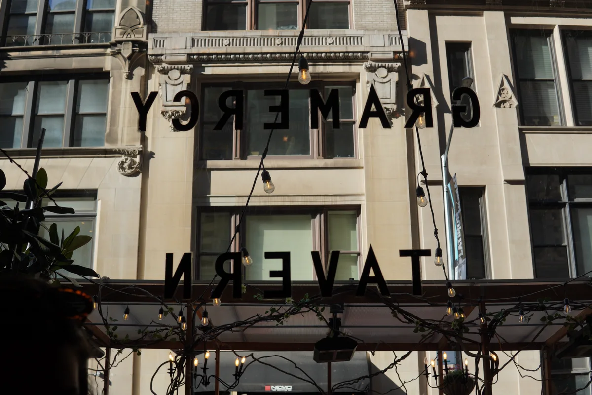 Buildings reflected in a Gramercy Tavern window